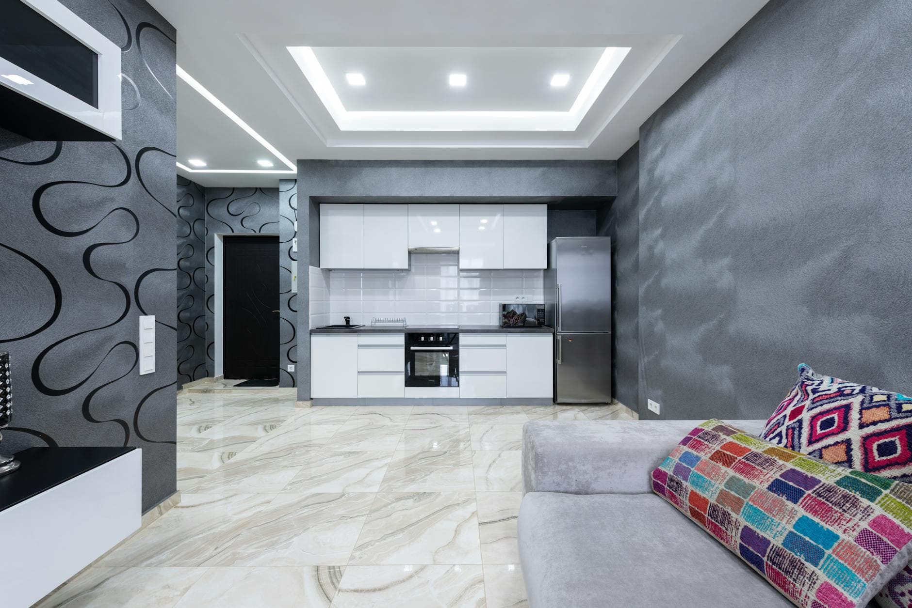 stylish kitchen zone and living room in modern apartment