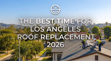 Image with two roofers working on an LA house with the downtown skyline in the background.