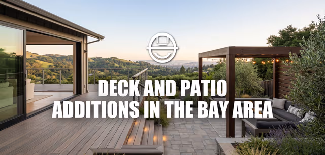 Wide-angle architectural photograph of a modern Bay Area hillside home, featuring a seamless indoor-outdoor transition to a large, multi-level composite deck and adjoining stone patio with a built-in fire pit, string lights, and modern pergola.